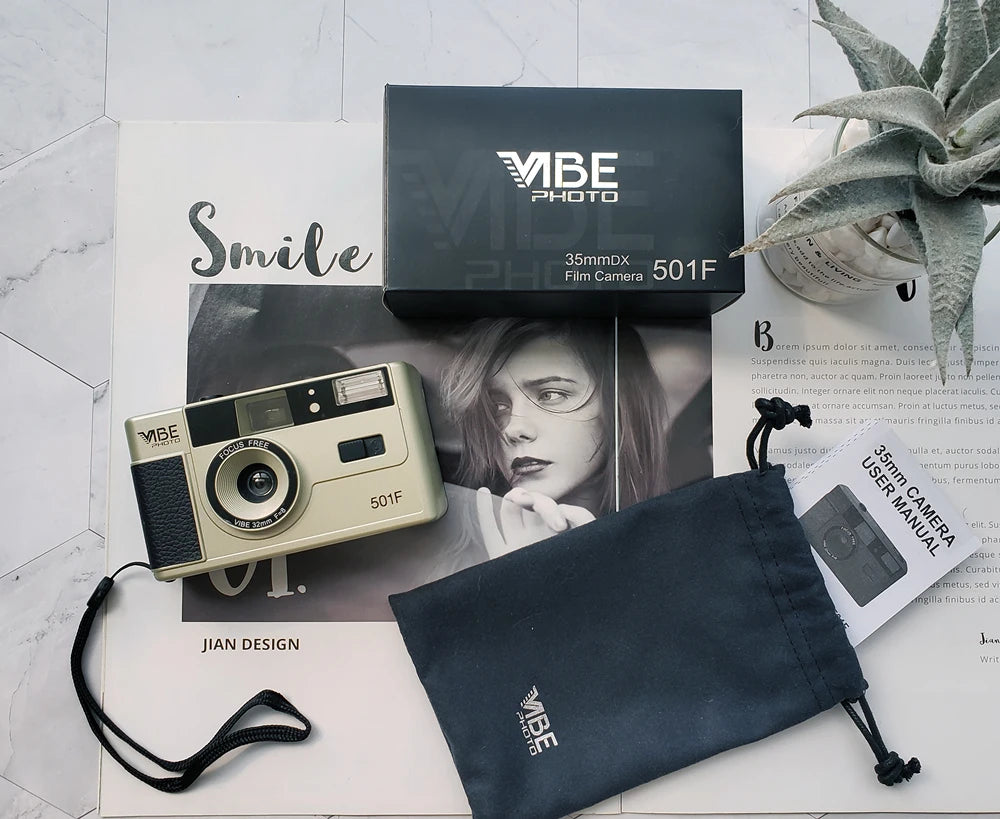 Vintage camera with accessories on a white surface